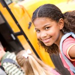 Child getting on School bus