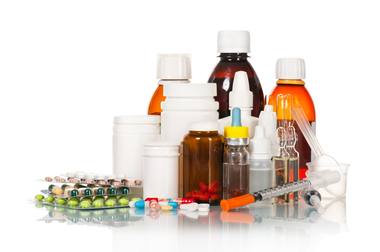 Different medical bottles and tablets isolated on white